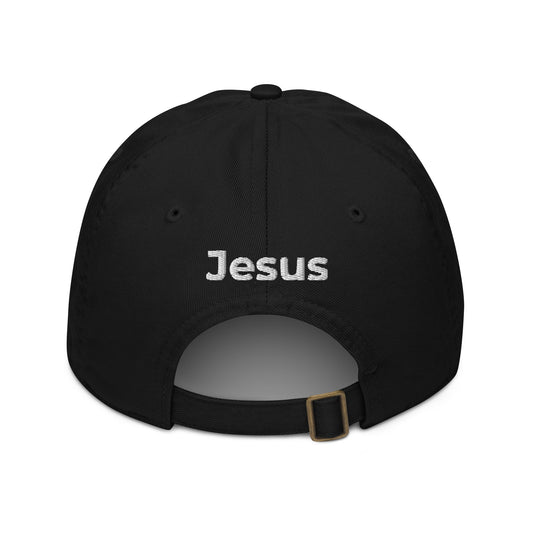 Back of black dad cap with the name of 'Jesus' embroidered in white above the adjustable strap.