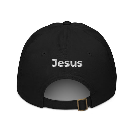 Back of black dad cap with the name of 'Jesus' embroidered in white above the adjustable strap.