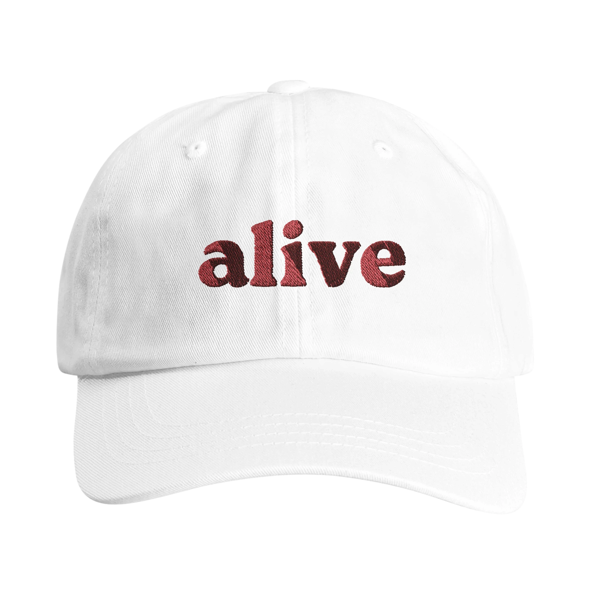 White dad hat with embroidered word 'Alive' on the front from Wearing Salvation's Helmet Collection