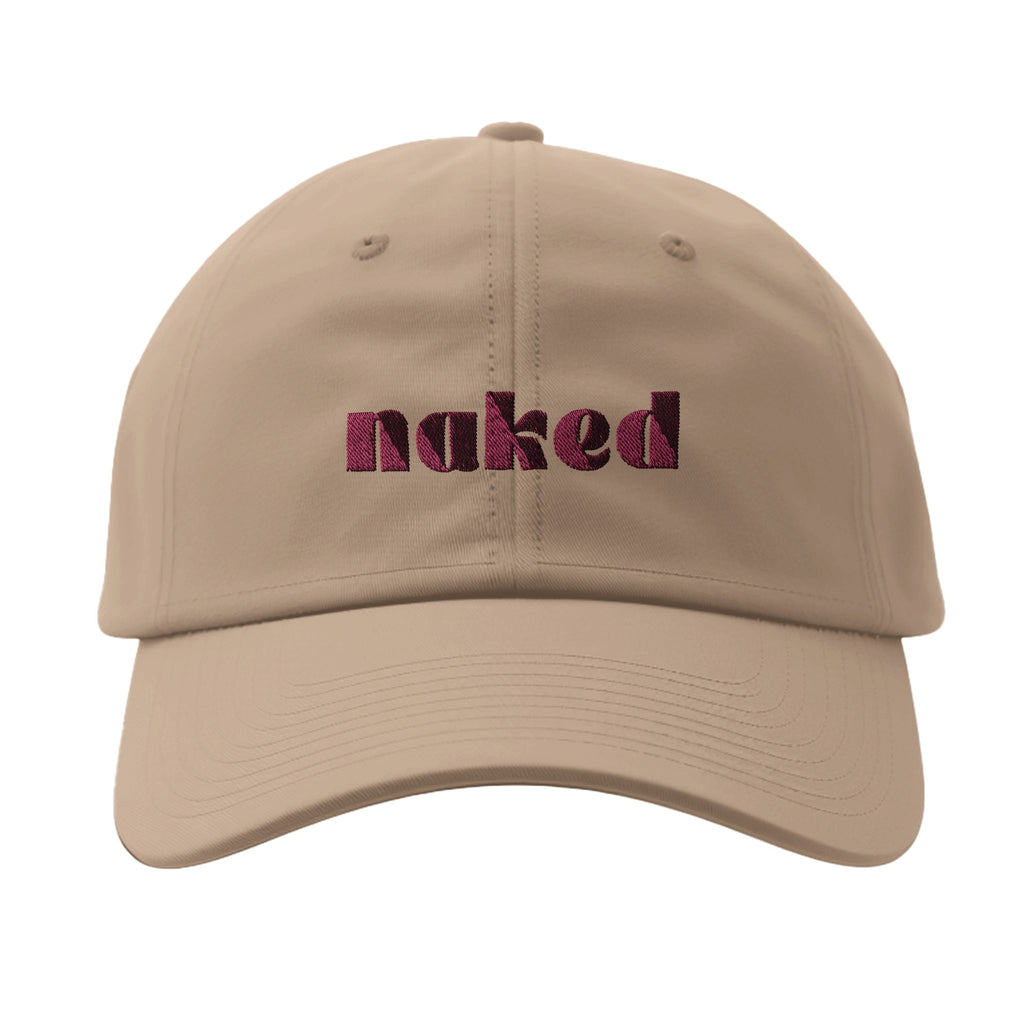 Front of women's beige Flexfit 6277 cap with pink lettering.