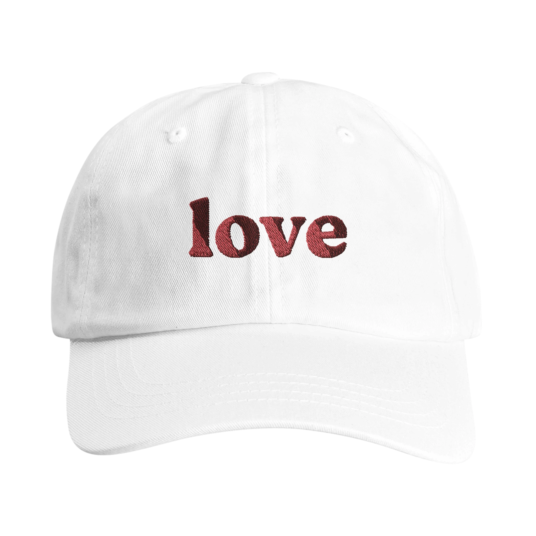 White dad hat with red embroidered word 'love' on the front from Wearing Salvation's Helmet Collection.
